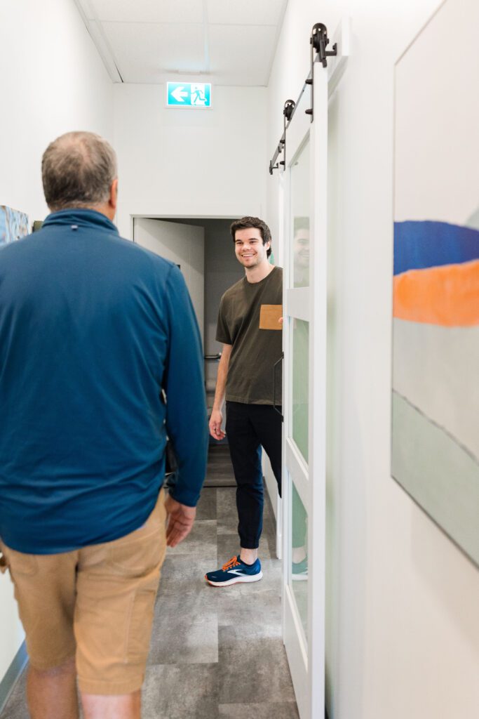 Client walking down the hall to meet Physiotherapist William Howatt