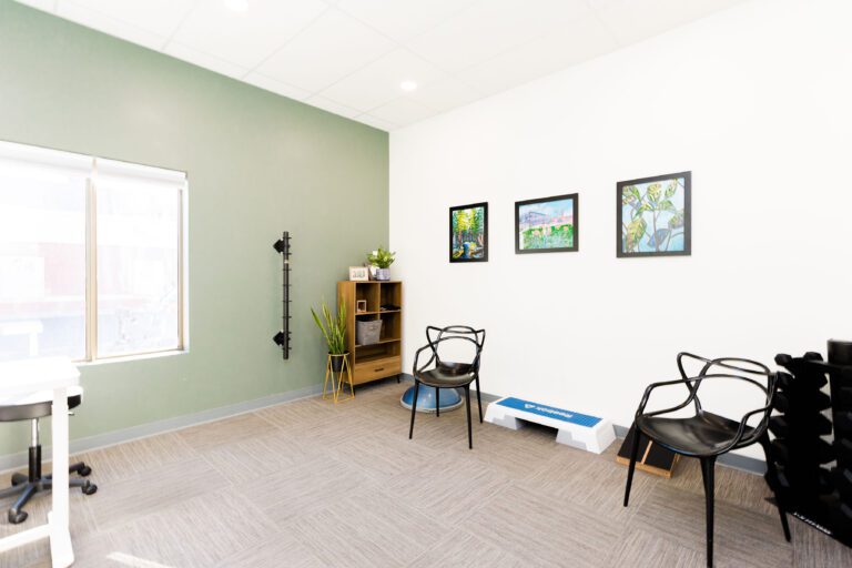 Picture of private treatment room at WH Physiotherapy & Wellness. In photo wall art and exercise equipment is visible.