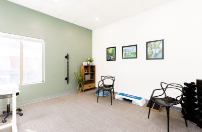 Picture of private treatment room at WH Physiotherapy & Wellness. In photo wall art and exercise equipment is visible.